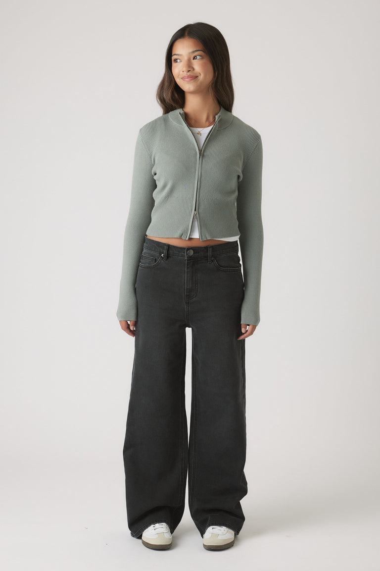 Girls Matilda Zip Up Knit in soft muted green with slim fit, styled with wide-leg black denim by DECJUBA Australian fashion brand