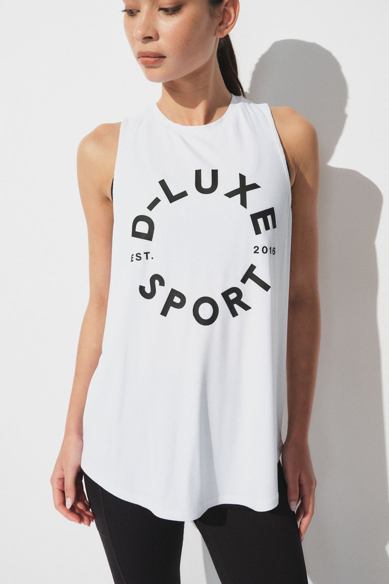 Woman wearing a white sleeveless bamboo tank with bold black logo lettering paired with black leggings for an active look