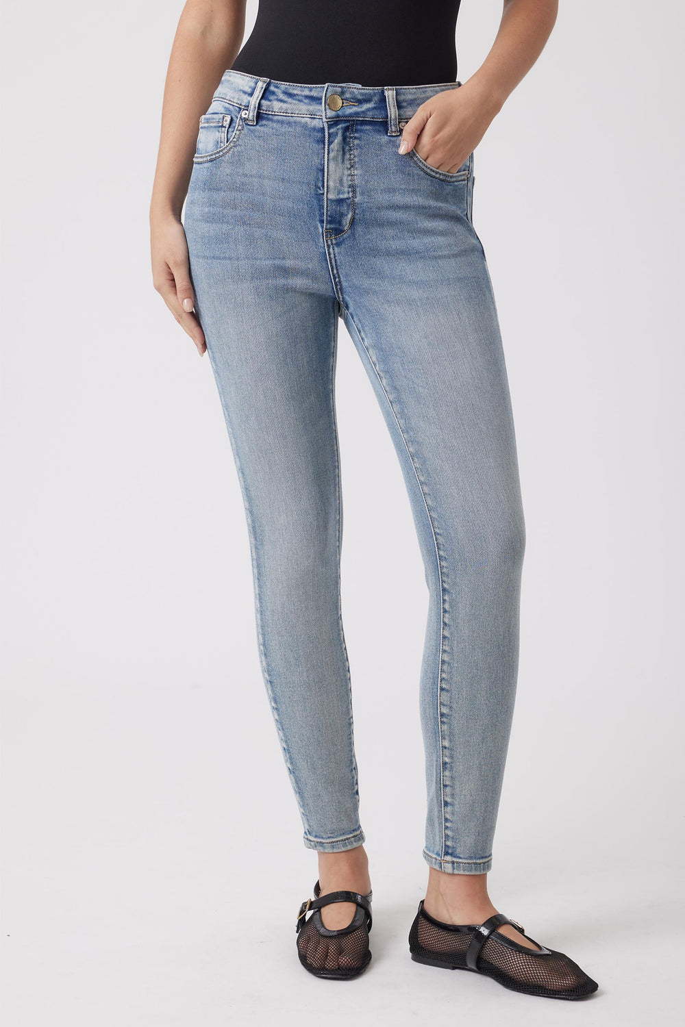 Light wash high-rise skinny jeans with subtle fading and classic five-pocket styling for a flattering fit.