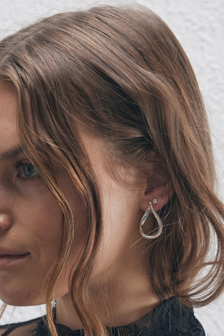 9ct Curved Teardrop Earring in polished silver tone by DECJUBA, an Australian brand for effortless, versatile elegance.