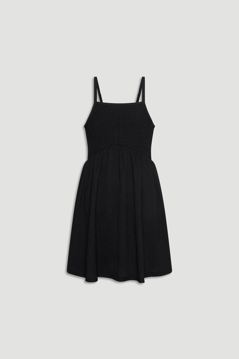 Black shirred girls dress with thin straps and a gathered skirt for an easy, stylish look.