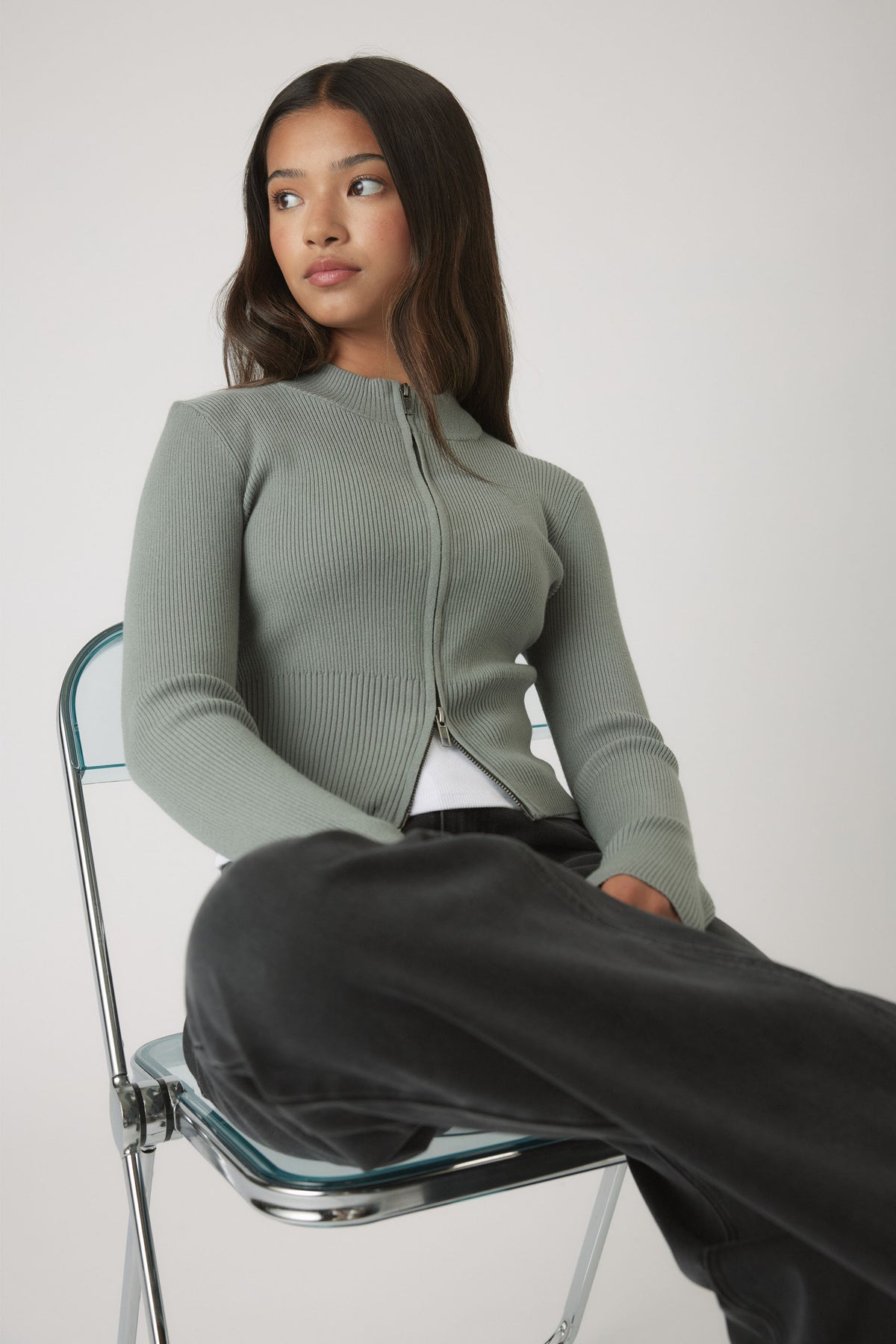 Girls Matilda Zip Up Knit in muted sage green with a slim fit, styled casually with black wide-leg pants by DECJUBA Australian brand