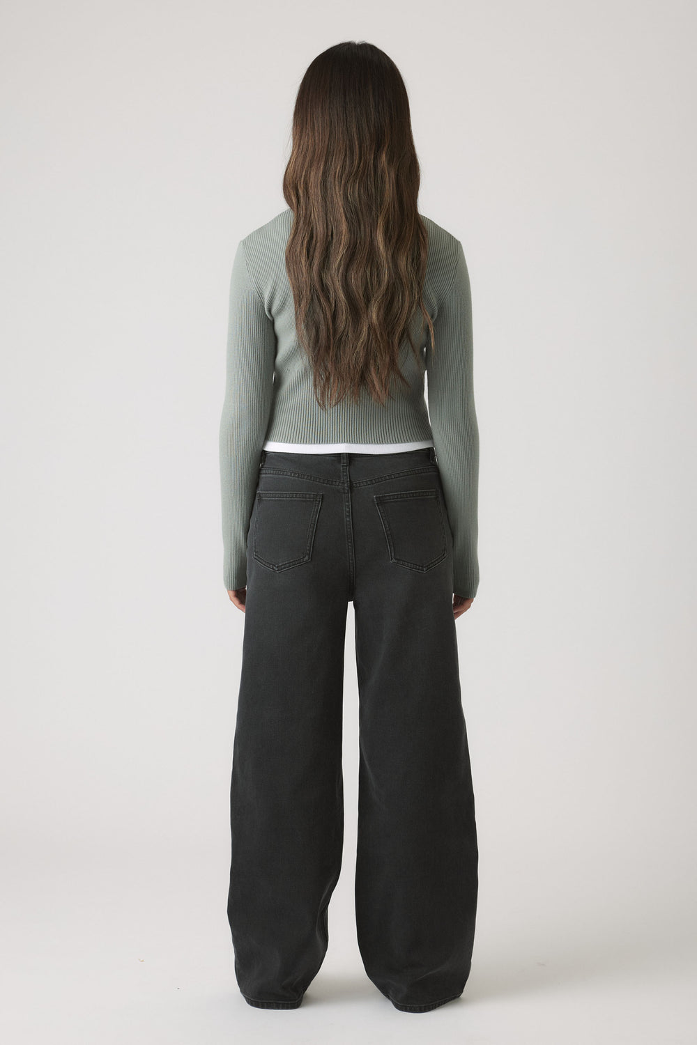 Girls Matilda Zip Up Knit in muted green with fitted silhouette, styled with wide-leg black denim for versatile casual wear by DECJUBA Australian brand