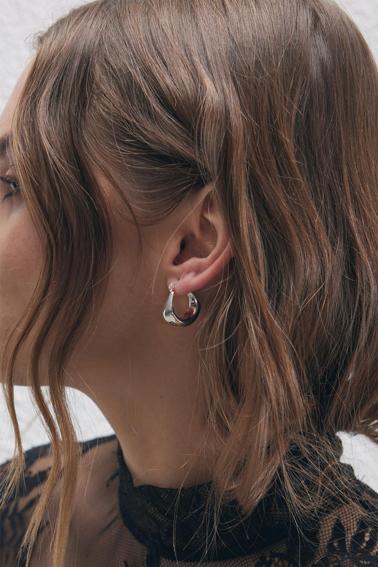 9ct Hanging Hoop Earrings in polished silver tone worn by woman with soft waves, by DECJUBA Australian fashion brand.