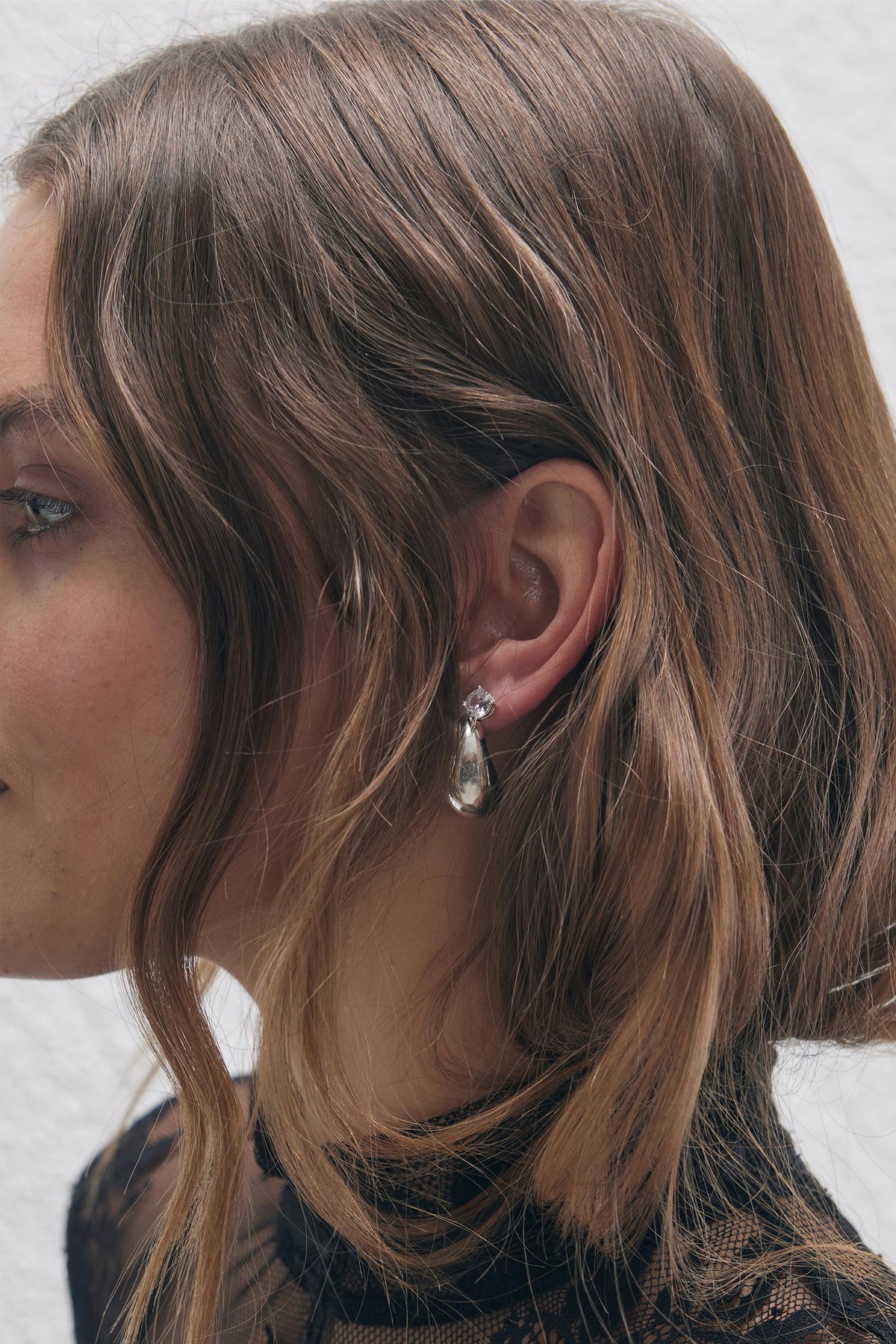 9ct Chunky Teardrop Earrings in polished silver tone worn by woman with loose waves, from DECJUBA Australian fashion brand.