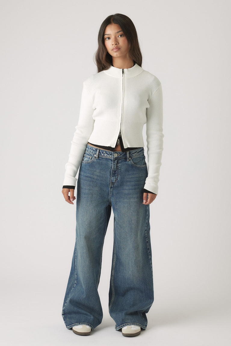 Girls Matilda Zip Up Knit in white ribbed knit with zip closure, paired with relaxed wide-leg blue denim by DECJUBA Australian brand