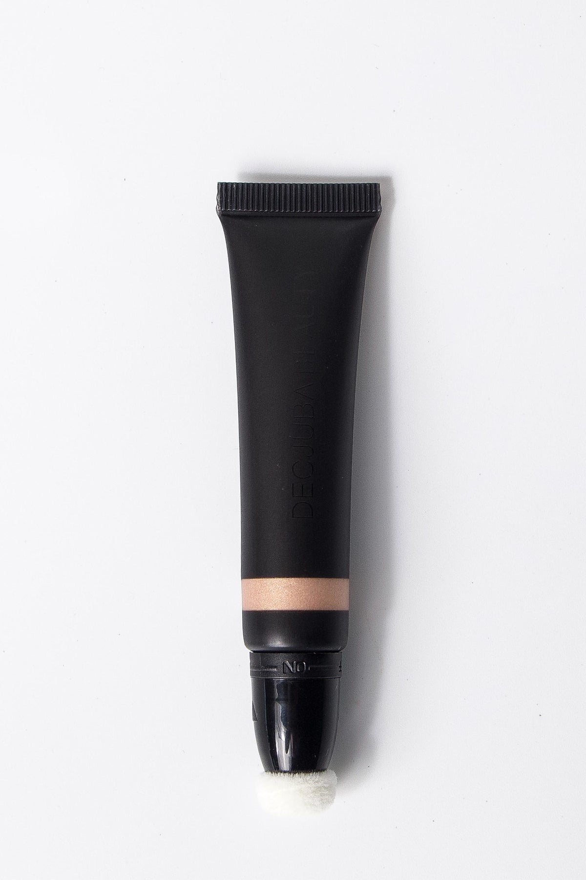 Black highlighting wand with sponge applicator for brightening the face