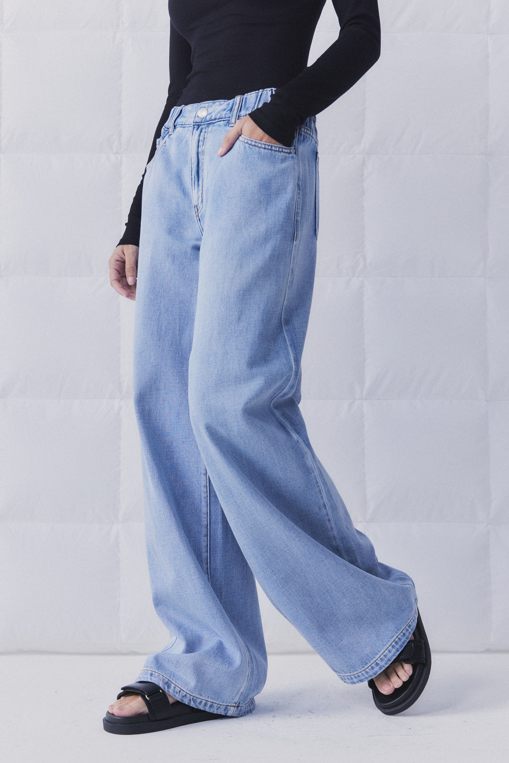 D-Luxe Wide Leg Jean in light denim with elasticated high rise waist, styled casually in portrait gallery image 3.