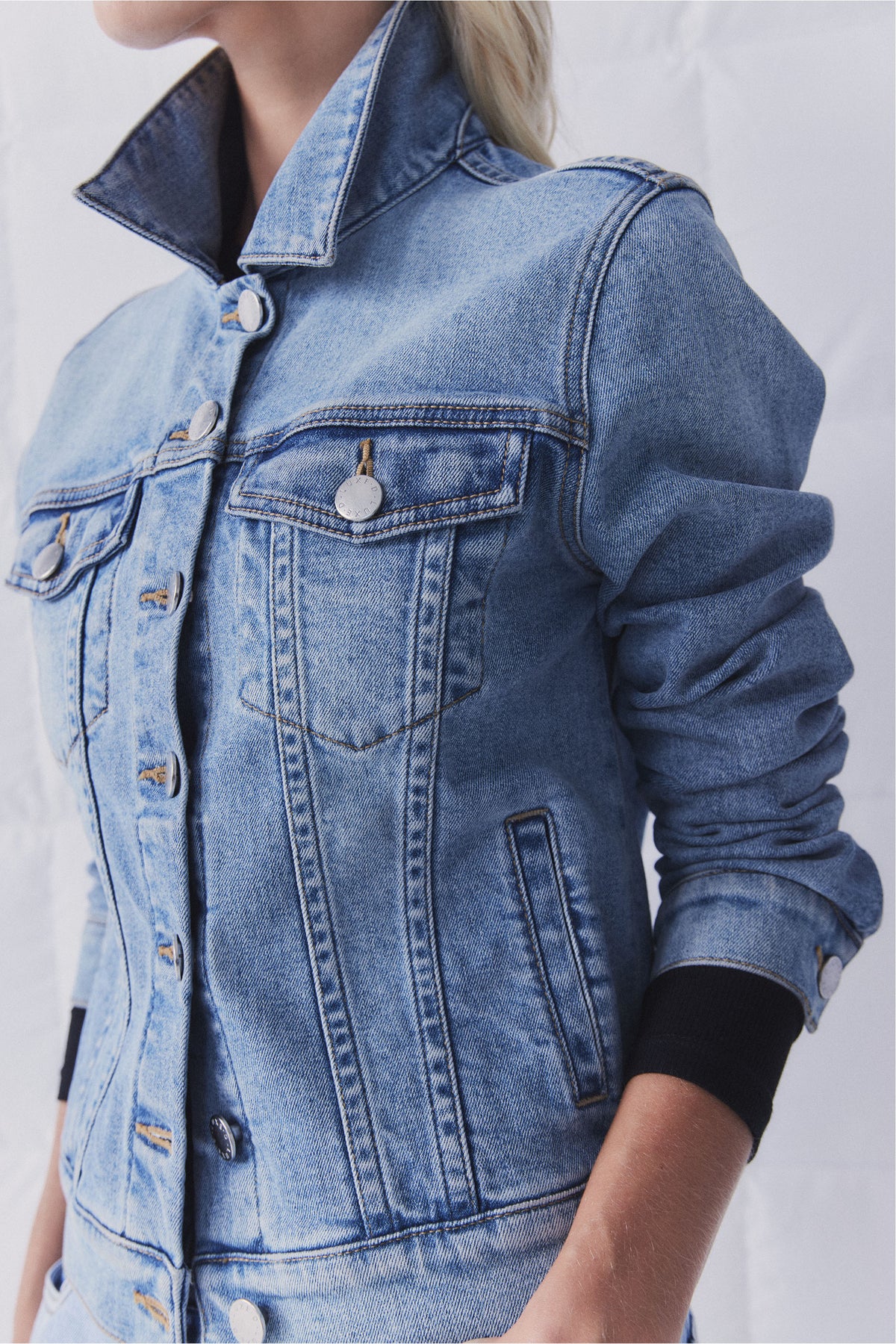 D-Luxe Sienna Denim Jacket close-up portrait showing collar, chest and side pockets, button details, and rolled sleeves.