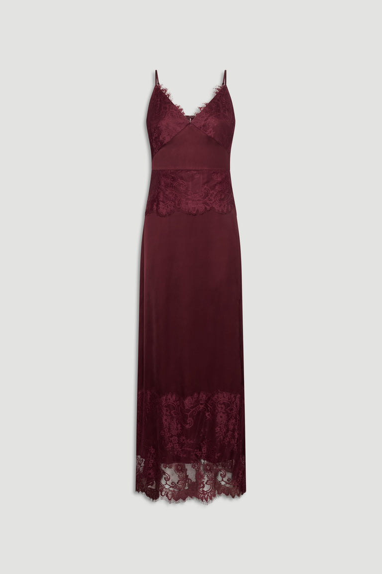 Plum lace maxi dress with delicate straps, featuring sheer lace panels at bust, waist, and hem for elegant texture.