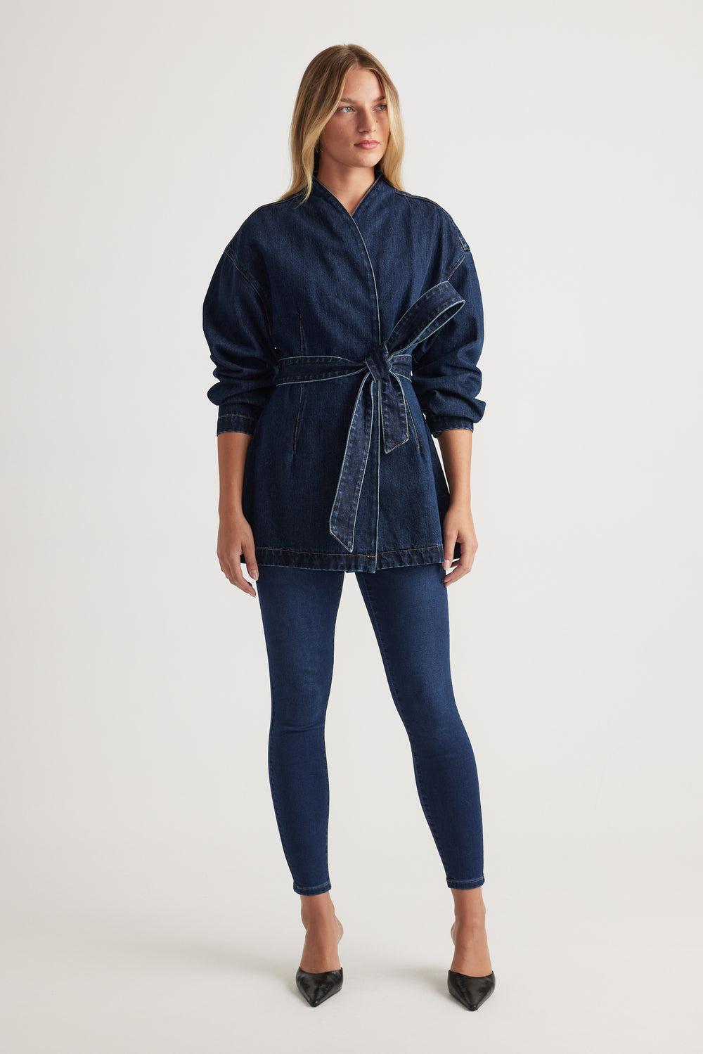 Model wearing Riley Crop Skinny Jean in dark indigo denim paired with belted denim jacket by Decjuba Australian brand
