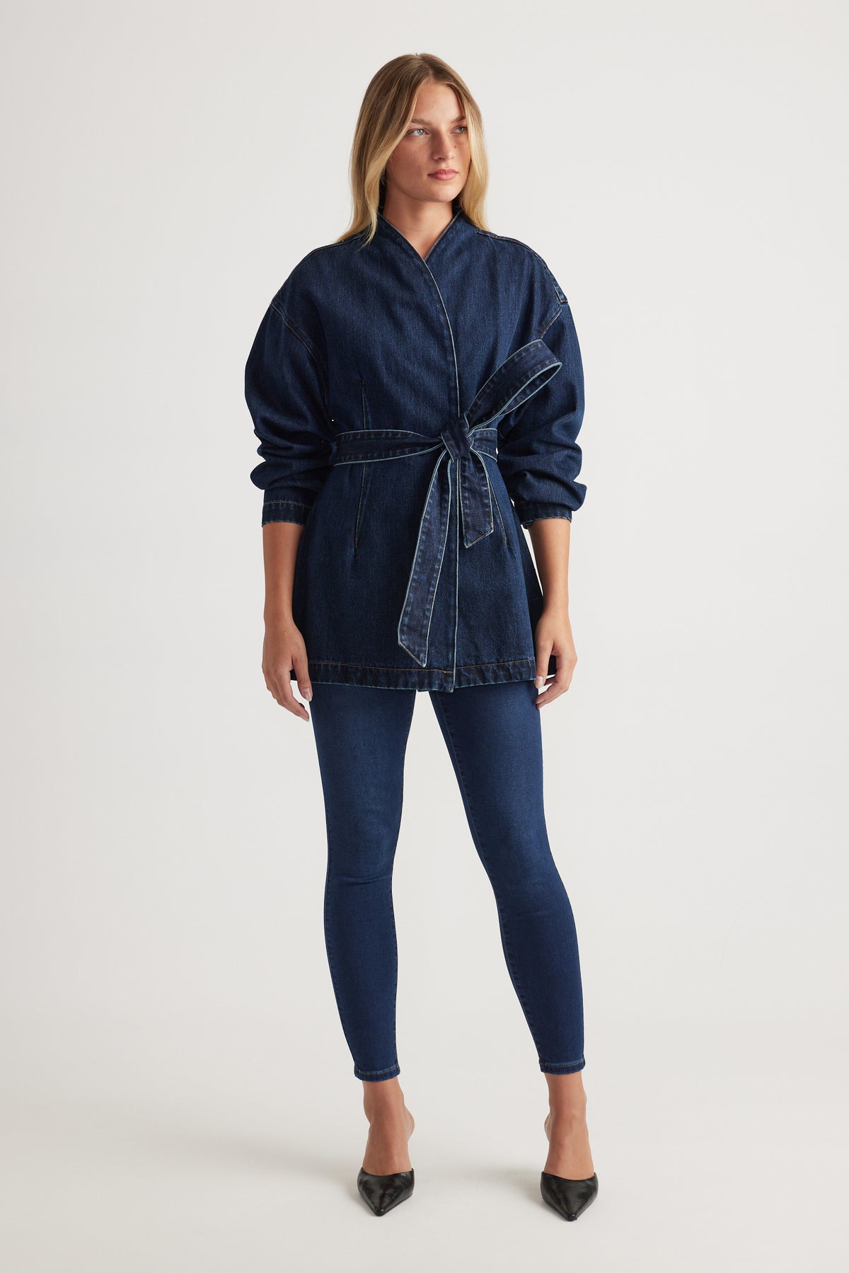 Model wearing Riley Crop Skinny Jean in dark indigo denim paired with belted denim jacket by Decjuba Australian brand