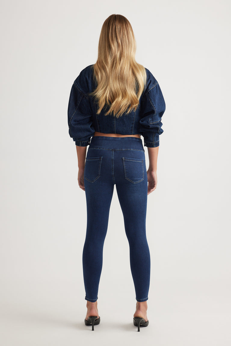 Rear view of model wearing Riley Crop Skinny Jean in dark blue denim paired with cropped denim jacket by Decjuba Australian brand