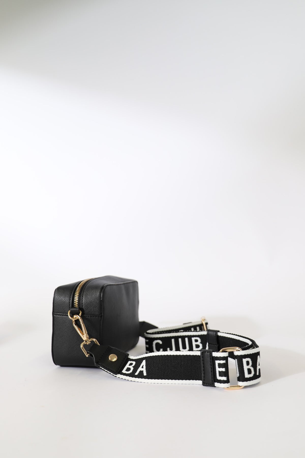 Decjuba Stripe Bag Strap in portrait, black with white branding, adjustable with metal lobster claw closure, gallery position 2.