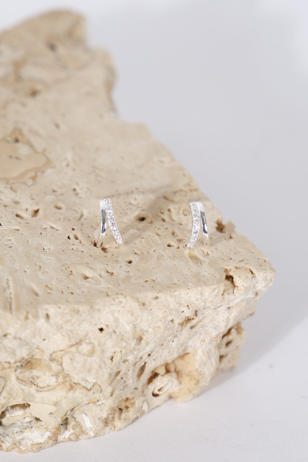 9ct double stone set earrings displayed on a natural stone surface
