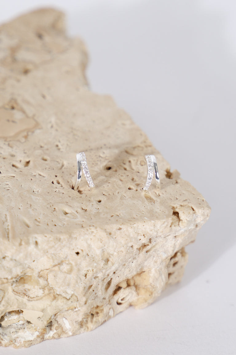 9ct double stone set earrings displayed on a natural stone surface