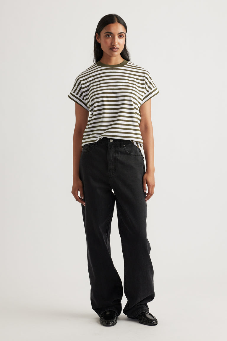 Woman wearing an olive and white striped Chloe Crew Tee with cuffed sleeves paired with loose black denim jeans