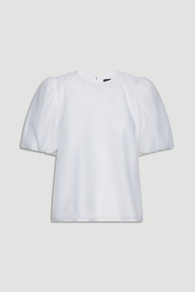 White top with voluminous puff sleeves and a simple round neckline for a chic, effortless look