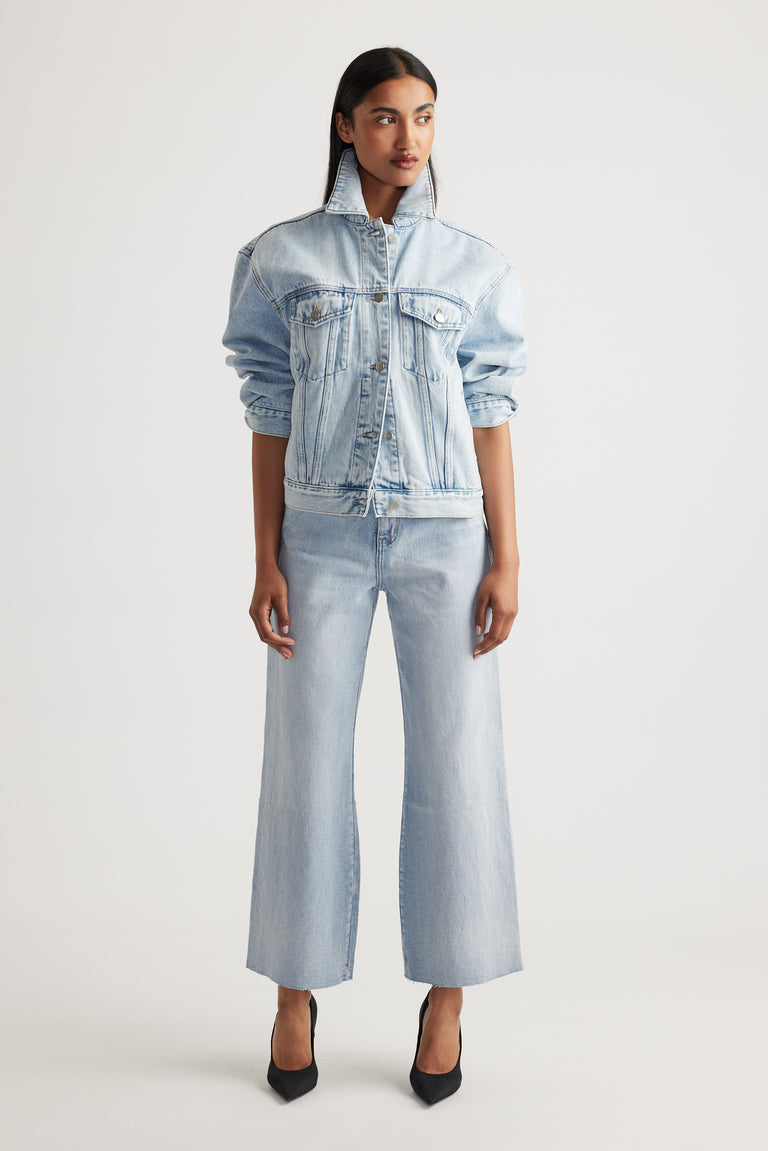 Woman wearing Tahni Wide Leg Jean in light denim styled with matching oversized denim jacket by Decjuba Australian brand