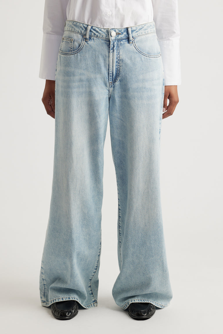 Front view of light wash Jenna Palazzo Jean styled with black shoes and white shirt by Decjuba Australian fashion brand