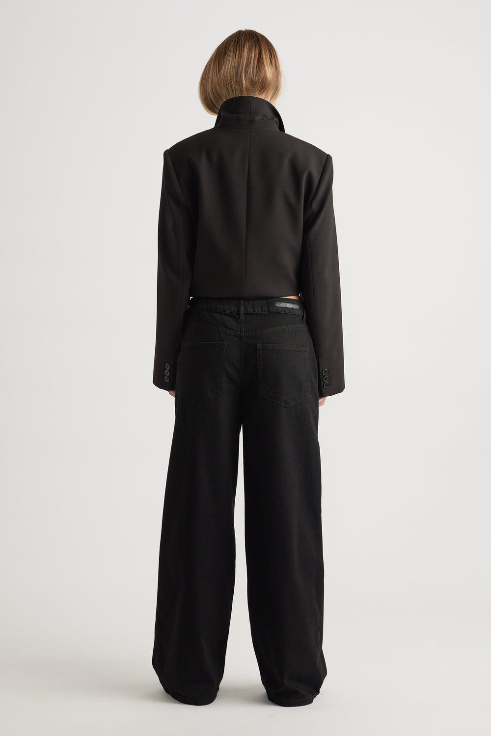 Rear view of wide leg Jenna Palazzo Jean in black cotton blend paired with tailored jacket by Decjuba Australian fashion brand