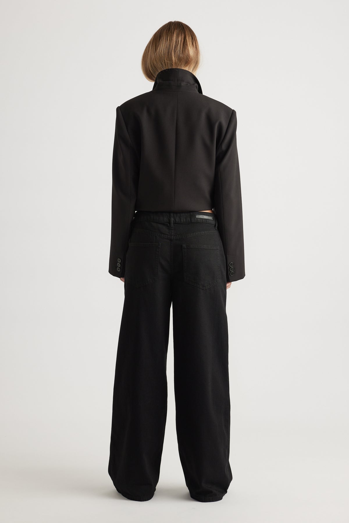 Rear view of wide leg Jenna Palazzo Jean in black cotton blend paired with tailored jacket by Decjuba Australian fashion brand