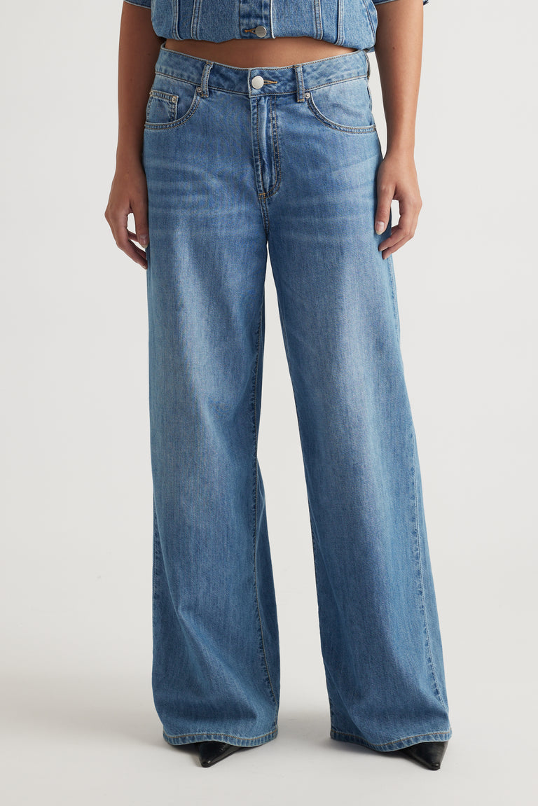 Front view of light wash wide-leg Jenna Palazzo Jean styled with denim top by Decjuba Australian fashion brand