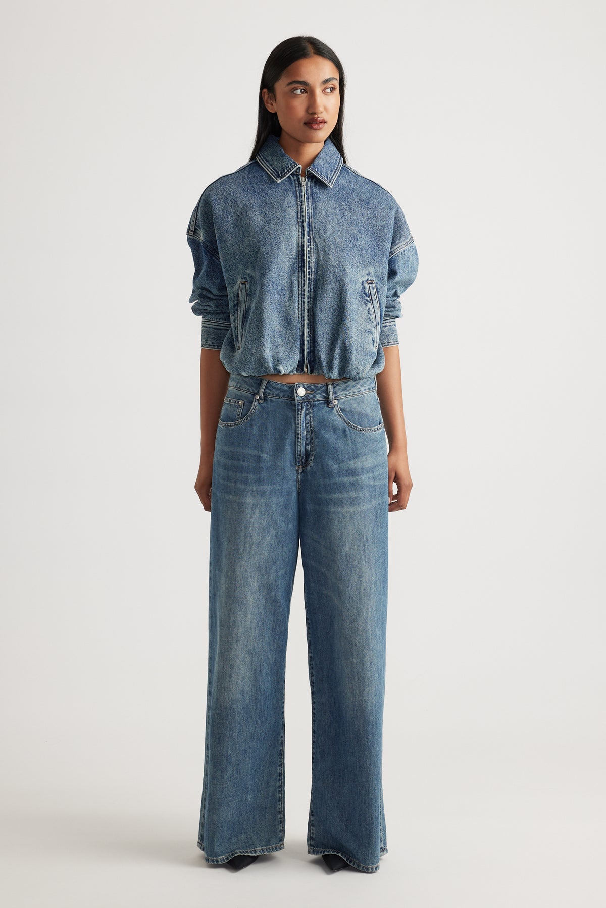 Front view of model wearing Jenna Palazzo Jean in relaxed wide leg denim paired with cropped denim jacket by Decjuba Australian brand