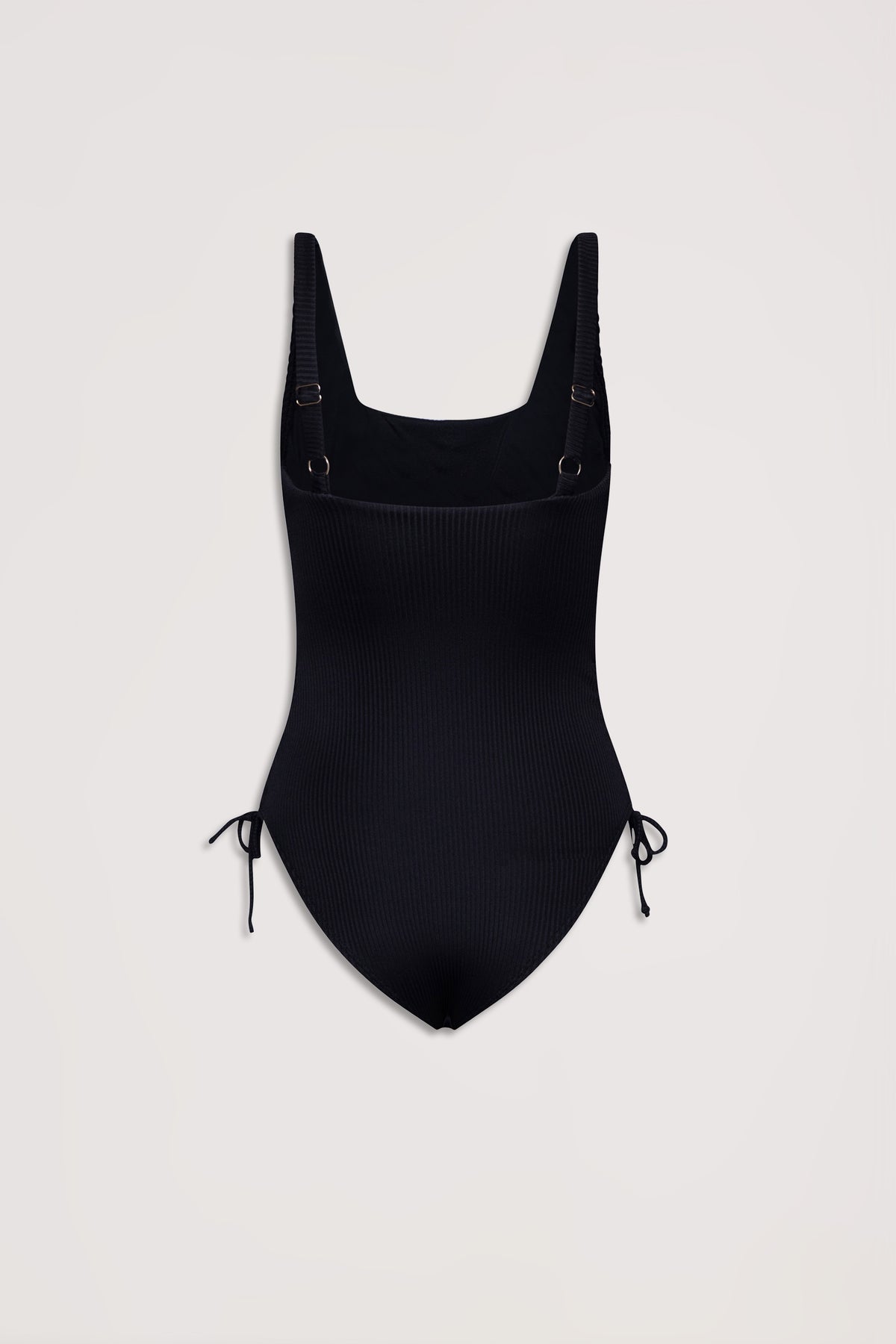 Black ribbed one-piece swimsuit with adjustable shoulder straps and side drawcord tie details on a plain background