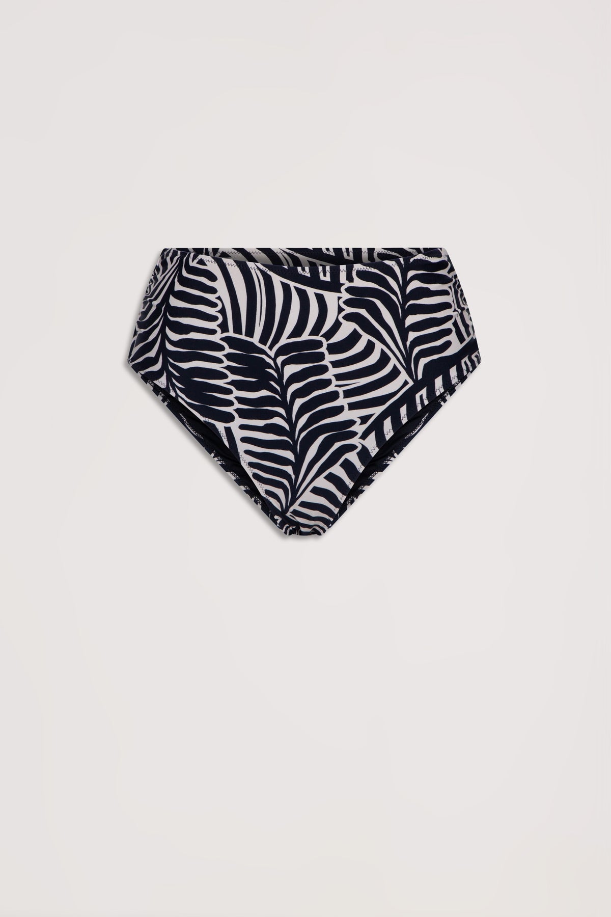 High-waisted bikini bottom with black and white tropical leaf print, laid flat against a light background