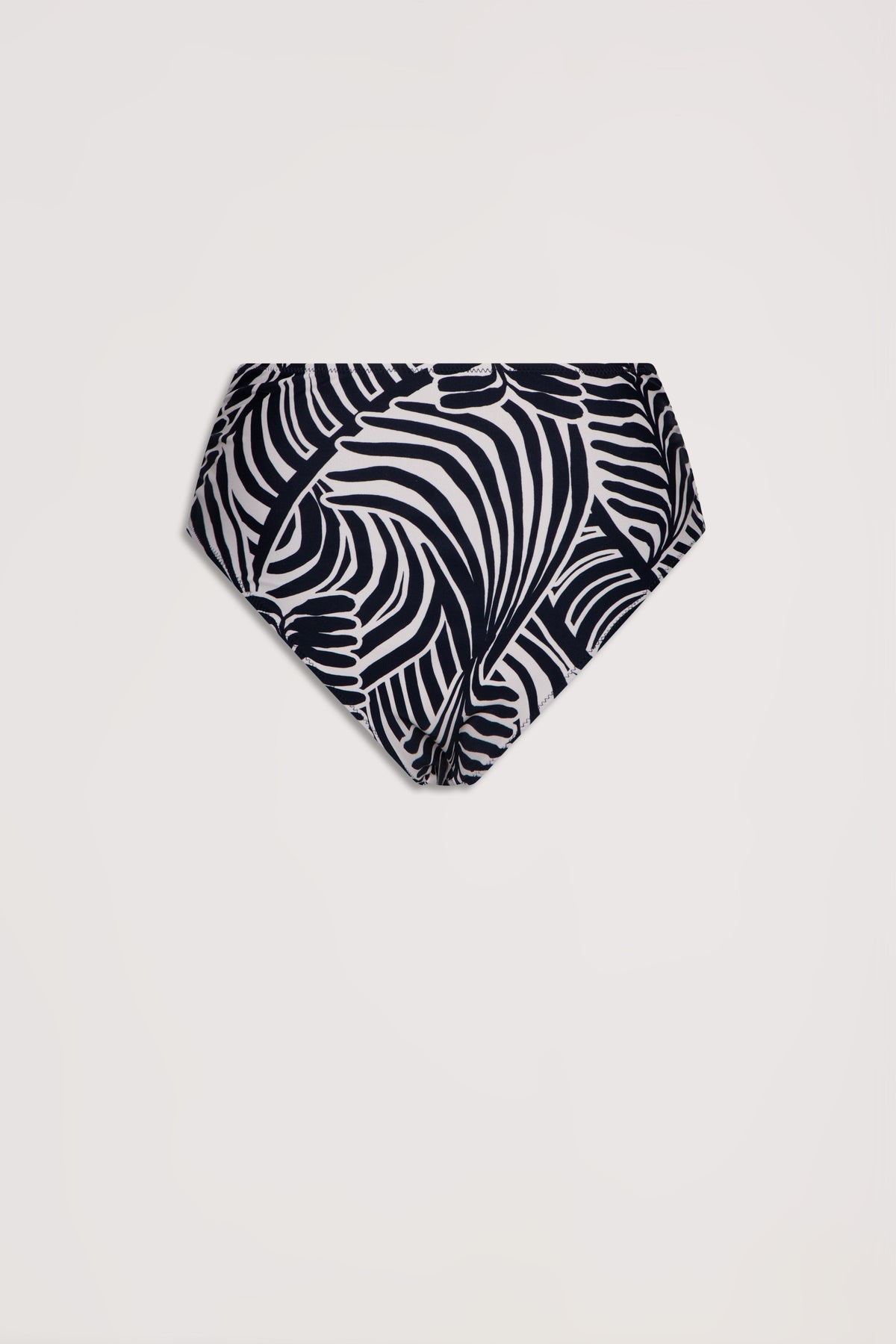 High-waisted bikini bottom in a bold black and white tropical leaf print with a matte finish.