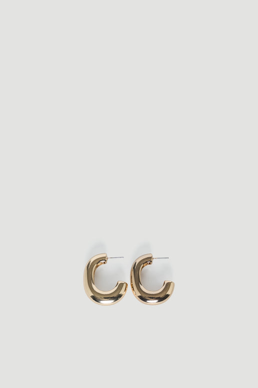 Gold chunky hoop earrings with stud closures on a light background