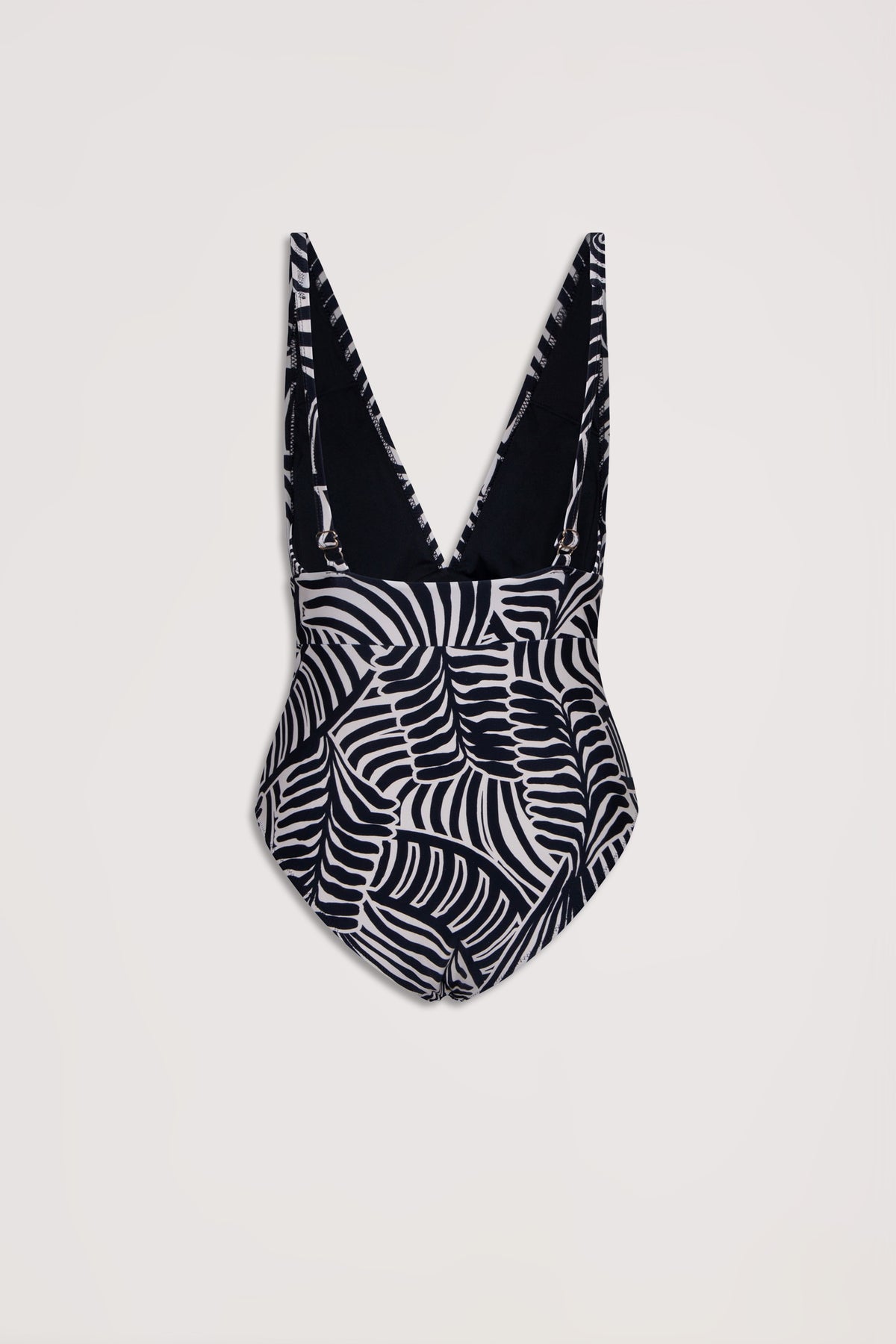 Black and white tropical leaf print one-piece swimsuit with a deep V back and adjustable shoulder straps