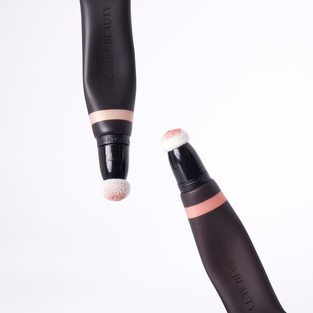 Two highlighting wands with soft sponge applicators in black and rose gold tones