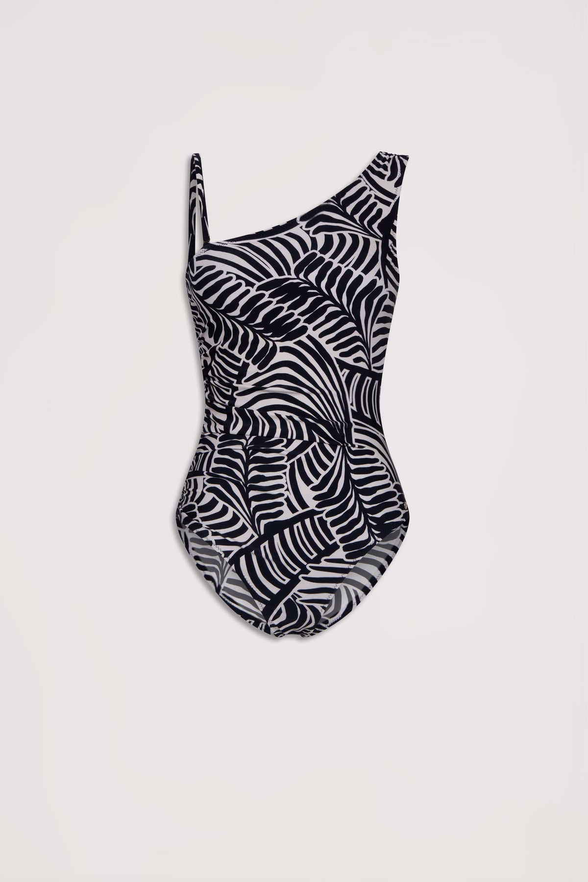 Black and white matte one-shoulder swimsuit with a bold abstract palm leaf pattern on a light background