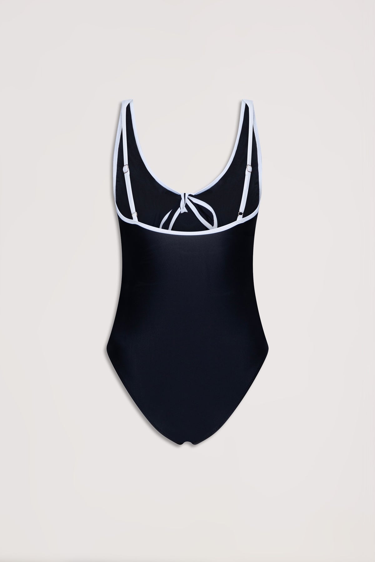 Black one-piece swimsuit with contrast white trim, adjustable straps, and a tie detail at the back neckline