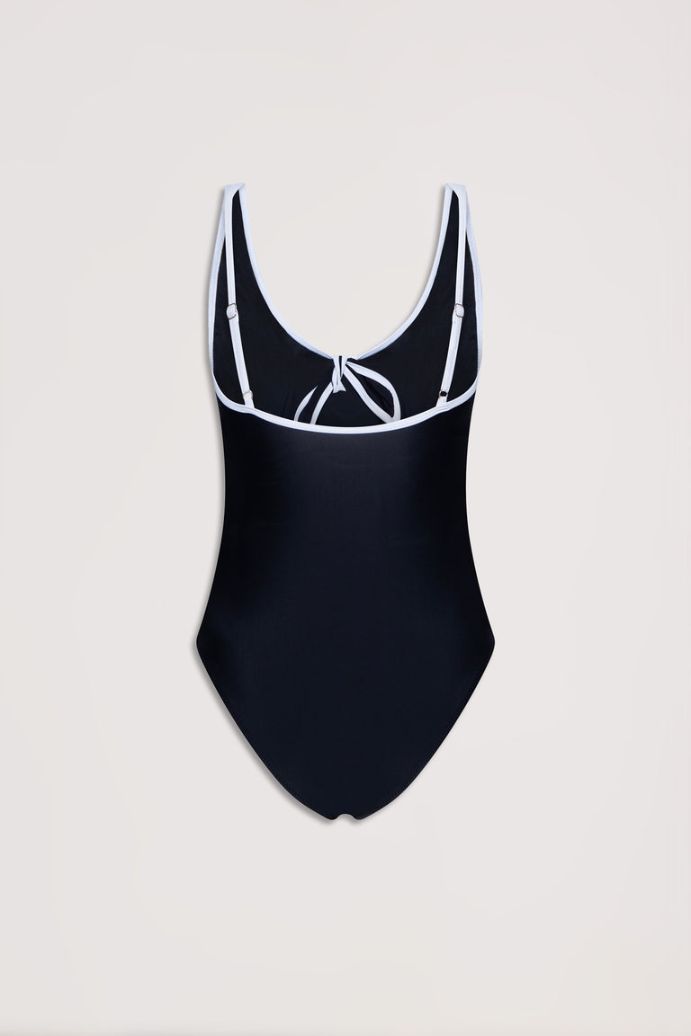 Black one-piece swimsuit with contrast white trim, adjustable straps, and a tie detail at the back neckline