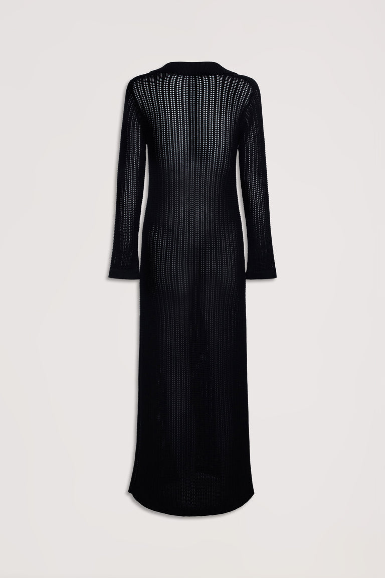 Back view of a long black crochet dress with long sleeves and an open knit pattern for a lightweight feel