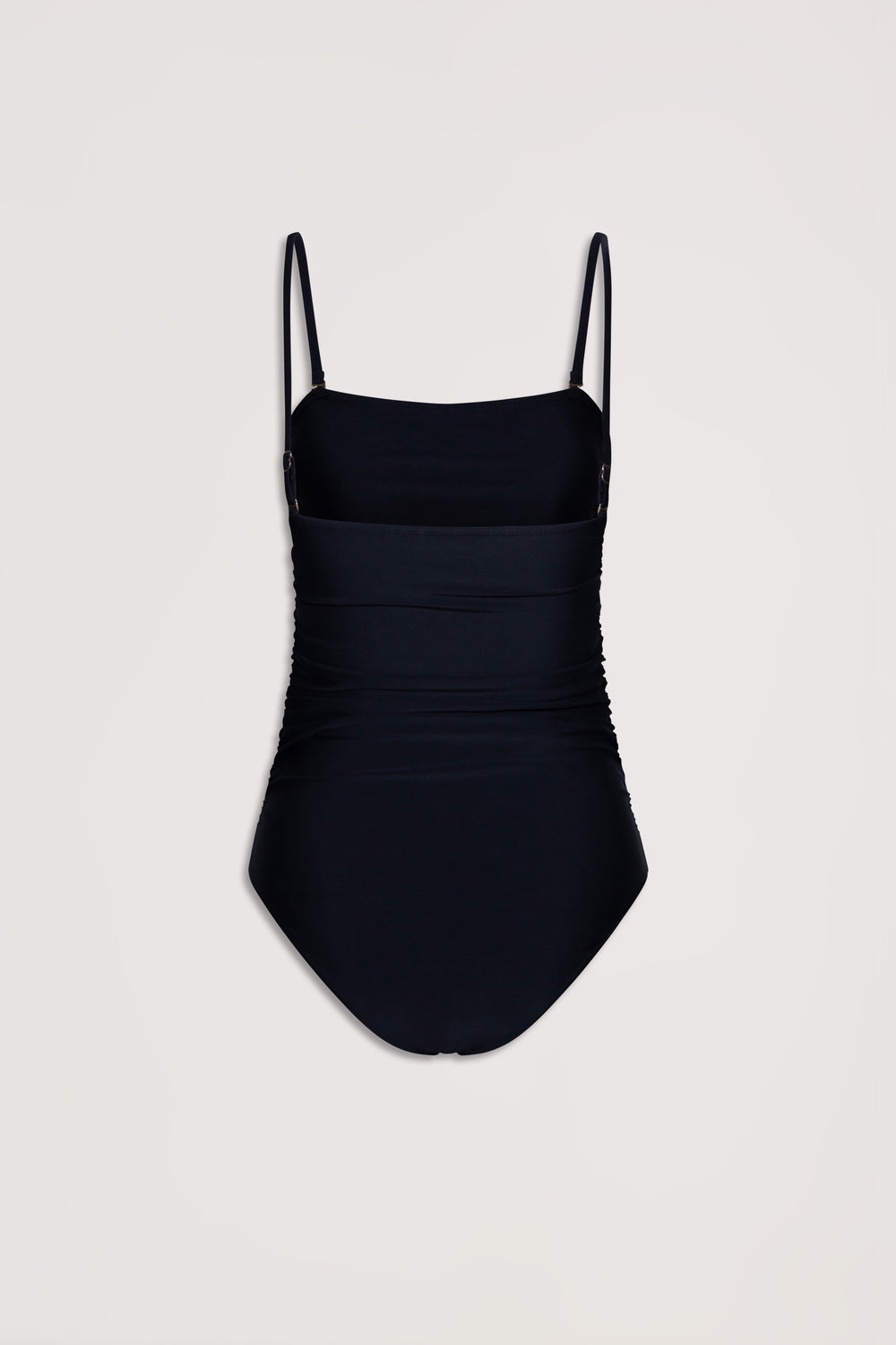 Black matte one-piece swimsuit with adjustable thin straps and subtle ruched detailing for a flattering fit