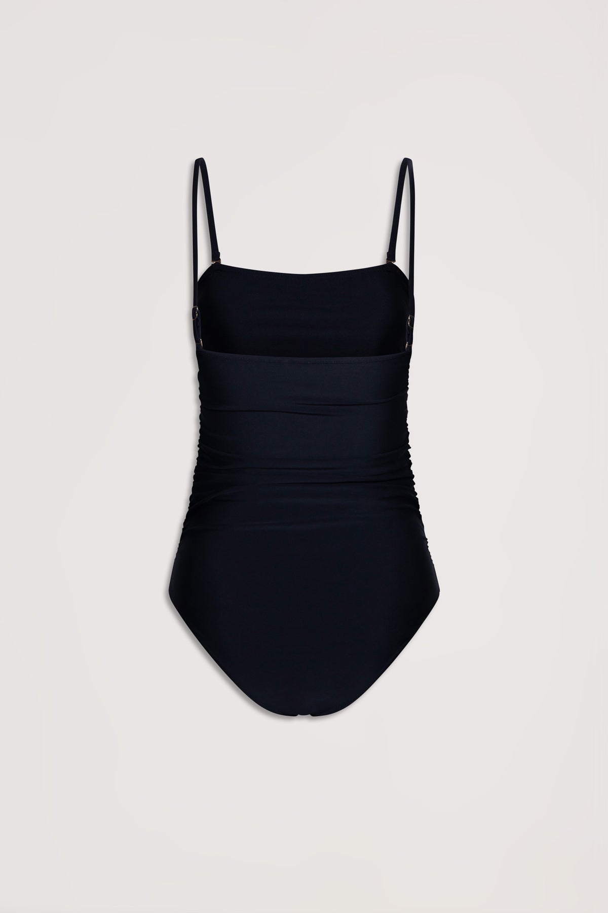Black matte one-piece swimsuit with adjustable thin straps and subtle ruched detailing for a flattering fit