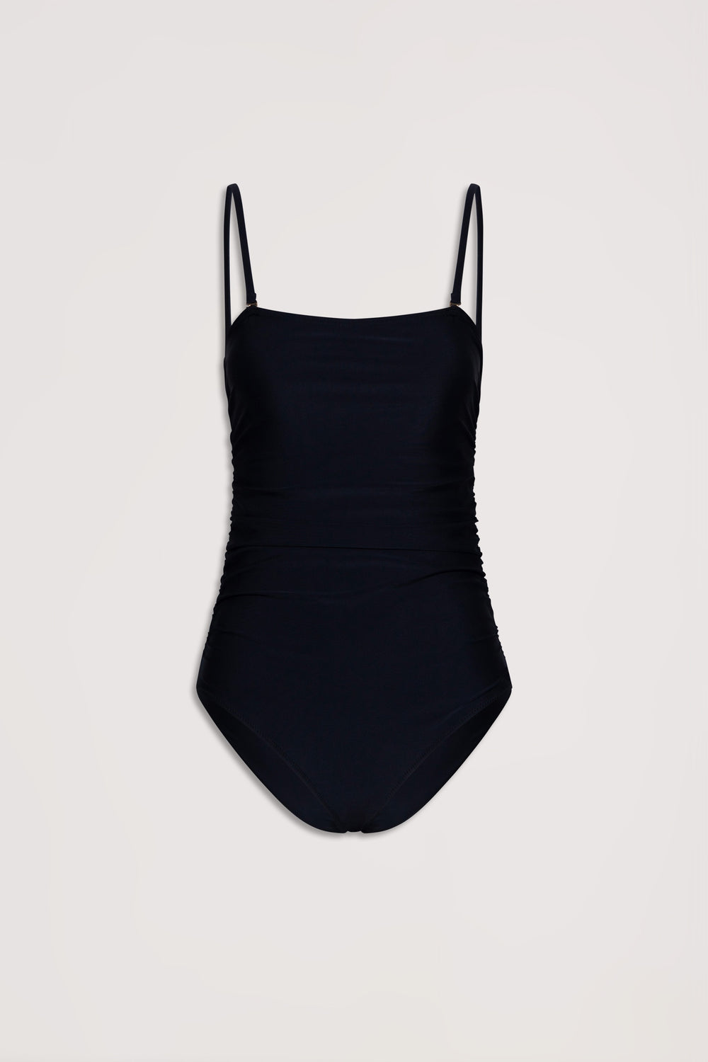 Black matte one-piece swimsuit with delicate ruched sides and thin adjustable straps on a neutral background