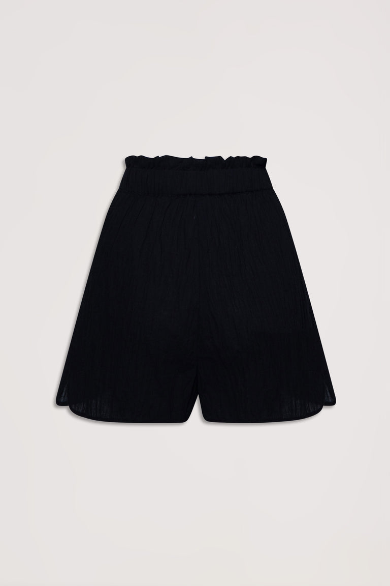 Black lightweight beach shorts featuring a gathered elastic waist and relaxed, flowy silhouette for effortless comfort.
