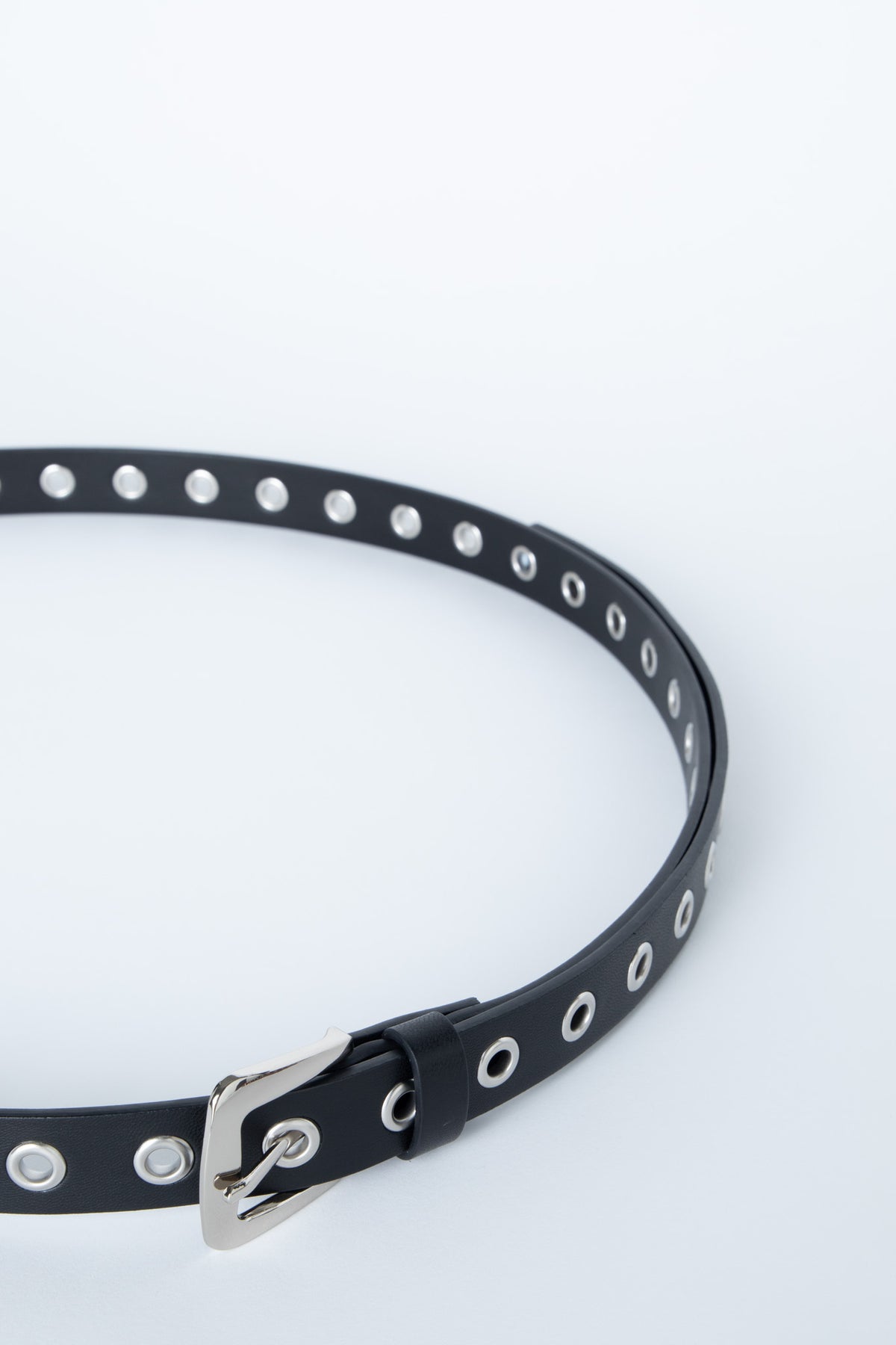 Black belt with silver eyelet detailing and adjustable buckle