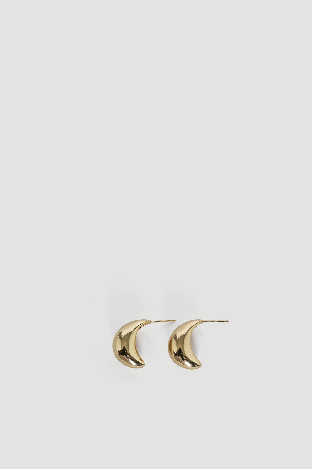 Pair of polished gold teardrop-shaped earrings with a chunky, smooth, and modern design for everyday elegance.