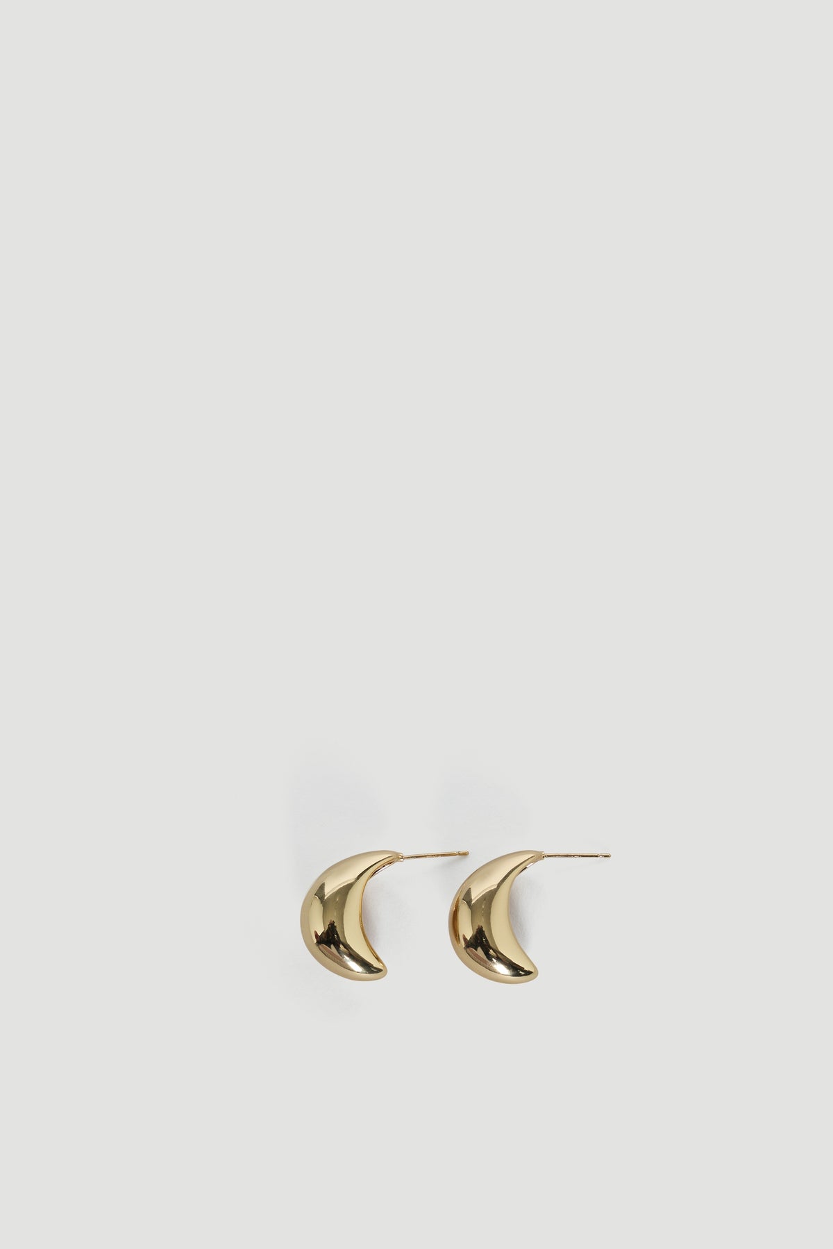 Pair of polished gold teardrop-shaped earrings with a chunky, smooth, and modern design for everyday elegance.