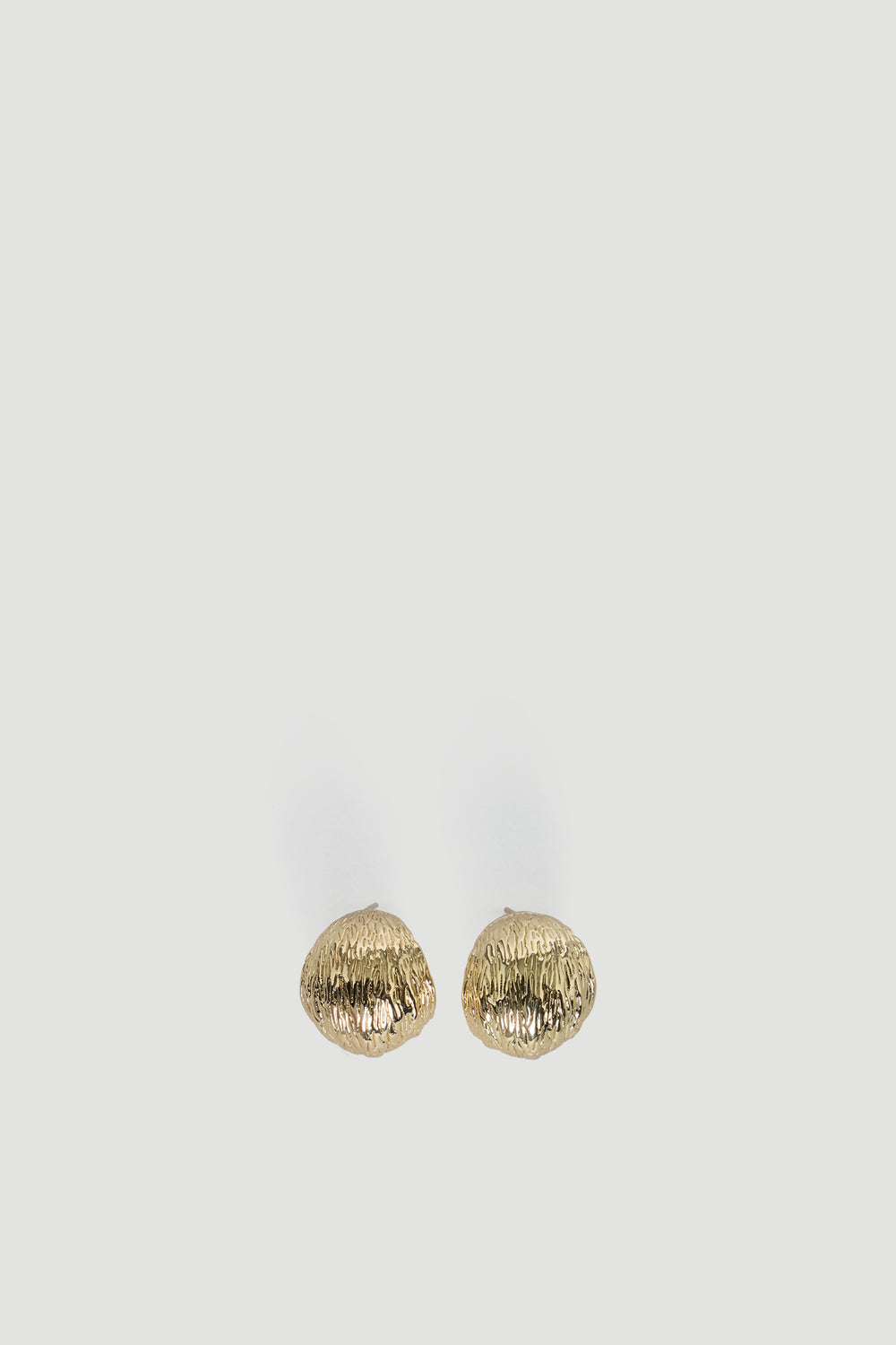 Pair of textured gold-tone chunky hoop earrings with an organic shape for a bold, modern accessory look.