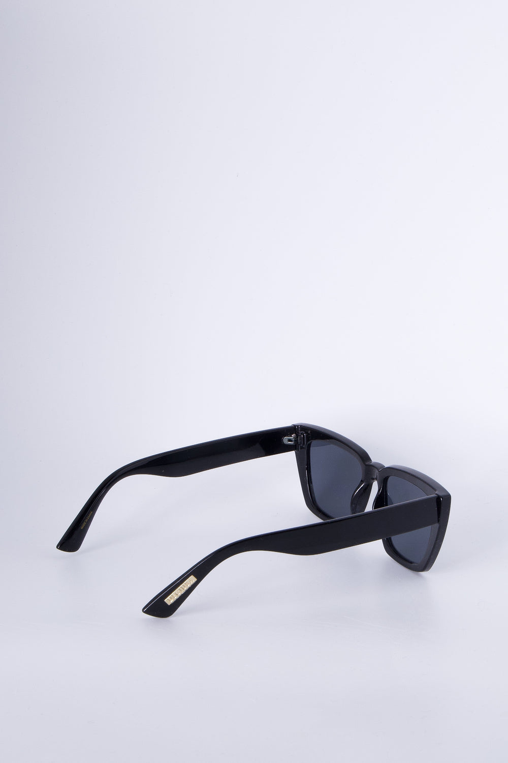 Sleek black angled cat eye sunglasses with bold frames and tinted lenses for a chic, modern accessory.