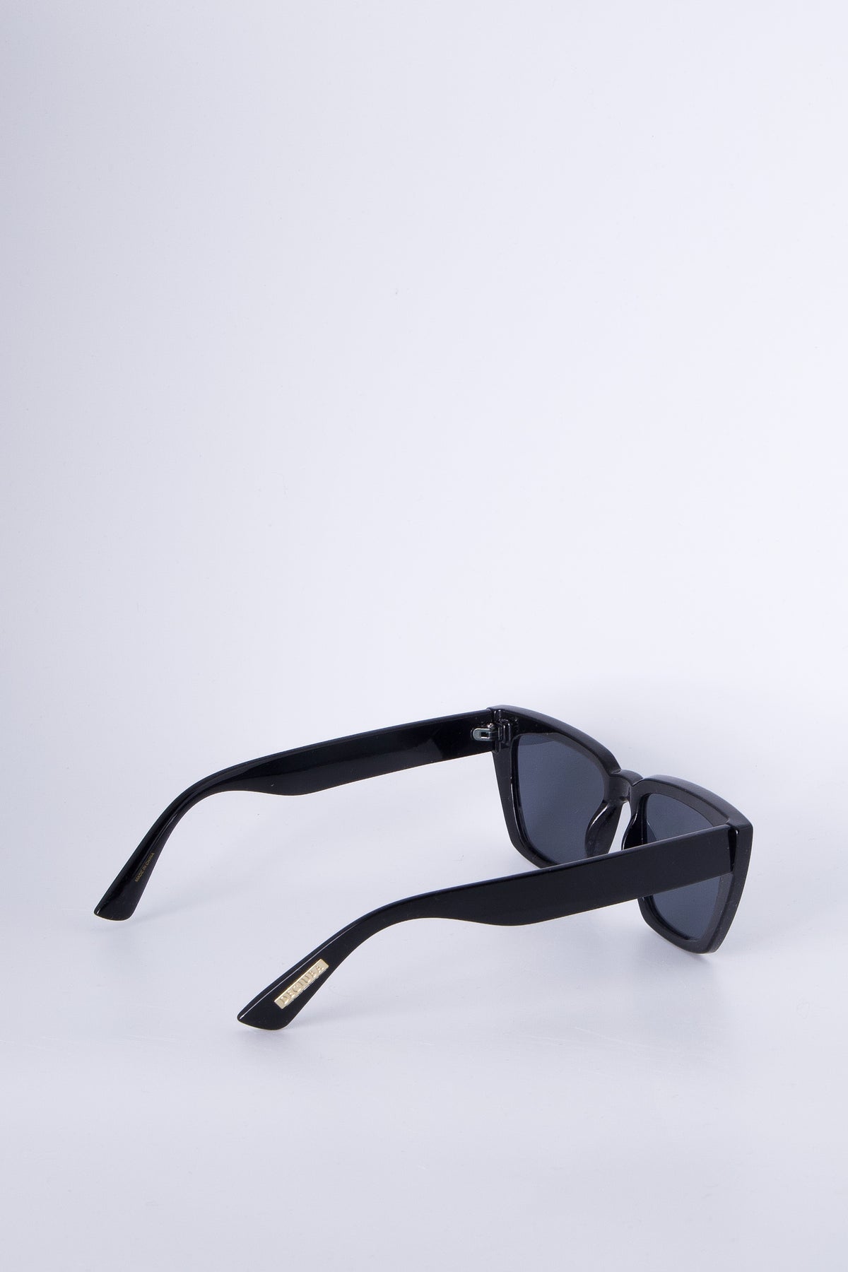 Sleek black angled cat eye sunglasses with bold frames and tinted lenses for a chic, modern accessory.