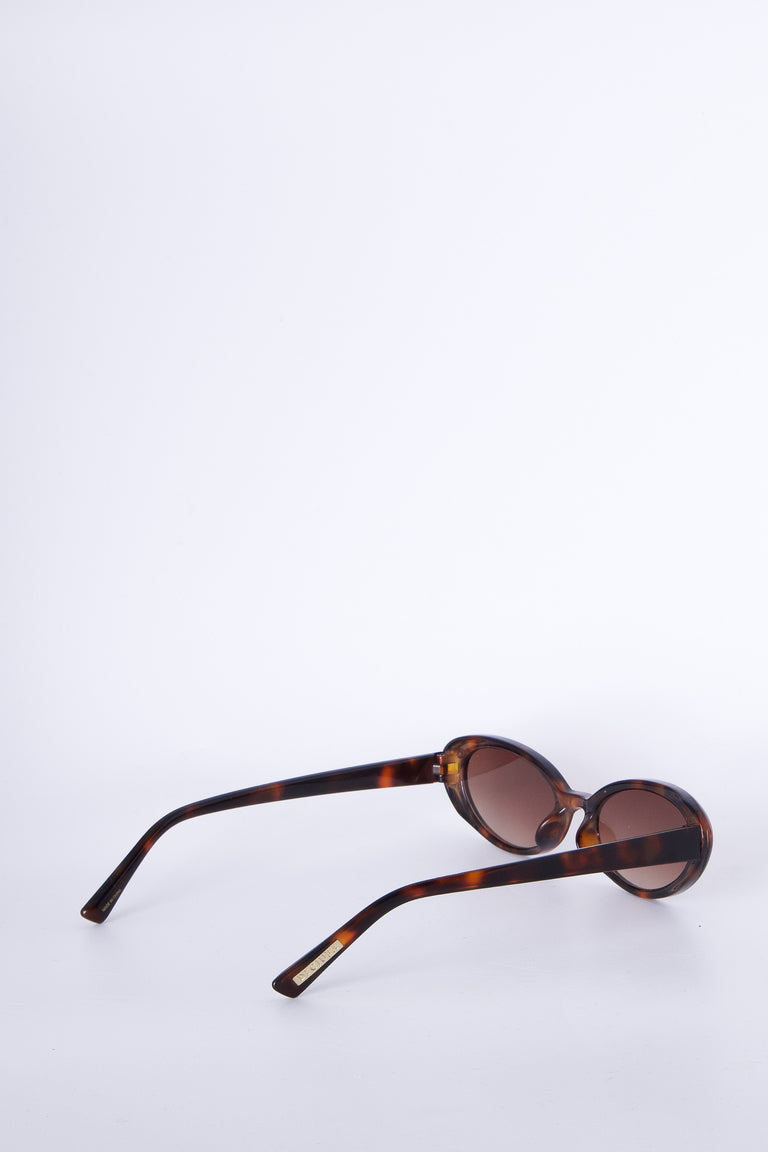 Sleek oval tortoiseshell sunglasses with brown tinted lenses, blending timeless style and everyday versatility.