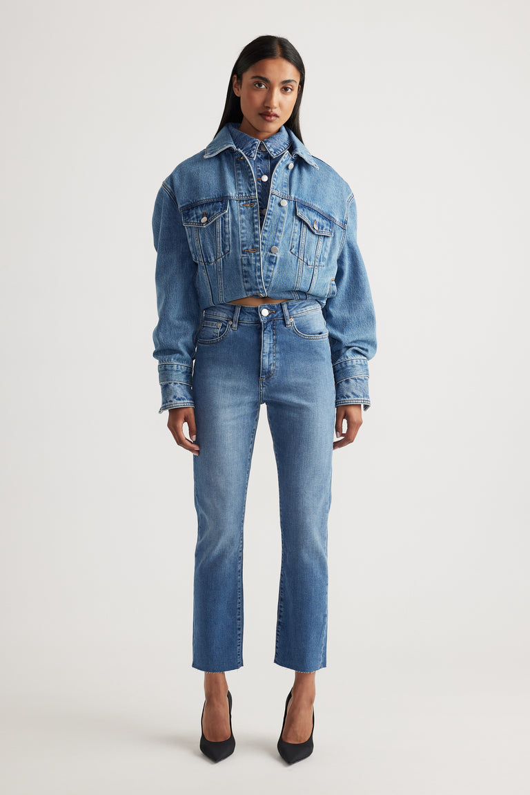 Model wearing Becky Straight Leg Jean in classic mid blue denim paired with cropped matching denim jacket by Decjuba Australian brand